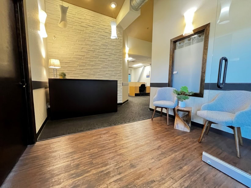 Modern coworking space at Office Evolution in Fort Collins with comfortable seating and welcoming at.