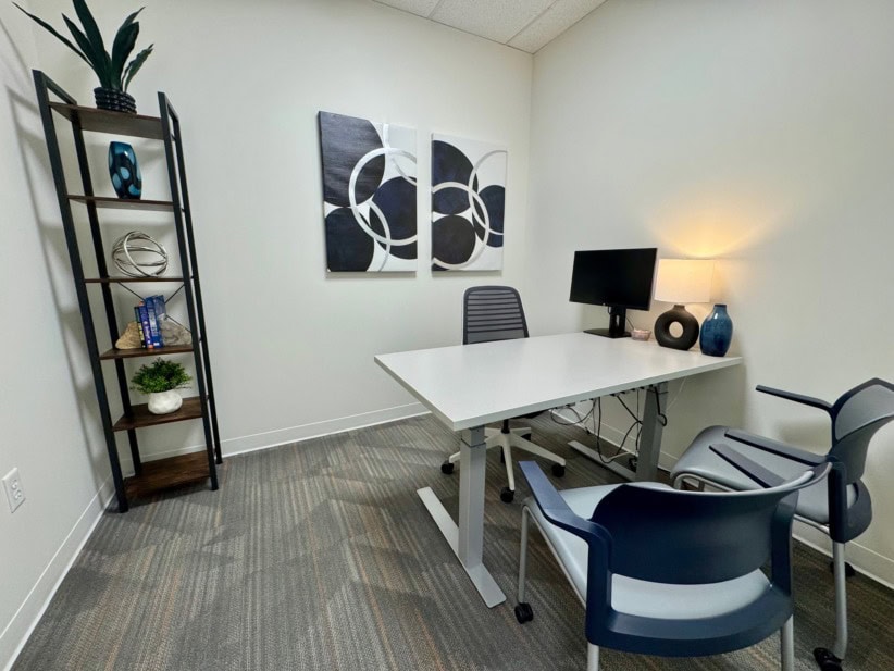 Office workspace with desk, chairs, and decor in Denver Metro North/Northglenn.