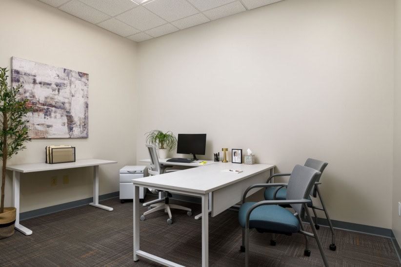 Modern office workspace with desk, computer, and chairs in High Point.