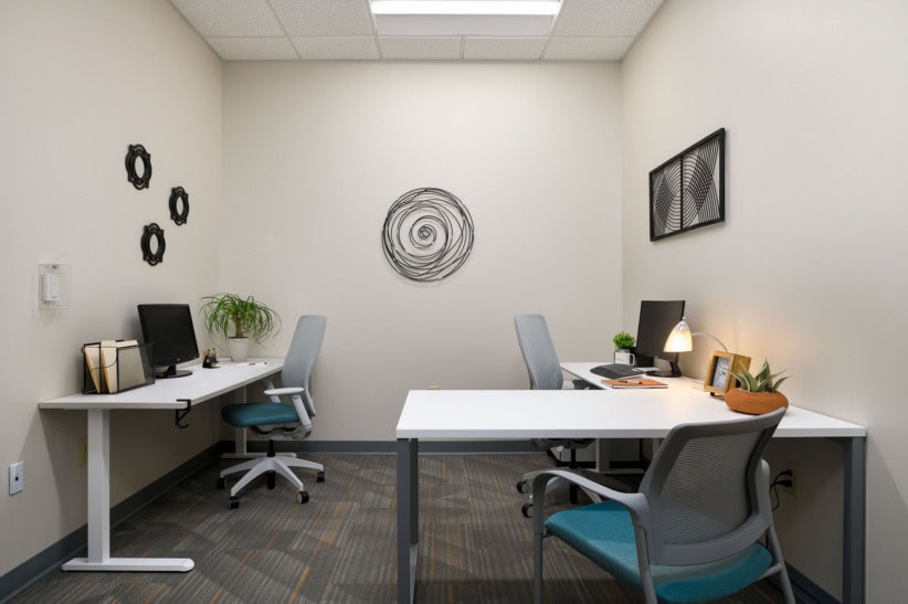 Modern shared office space with desks, chairs, and decor in High Point.