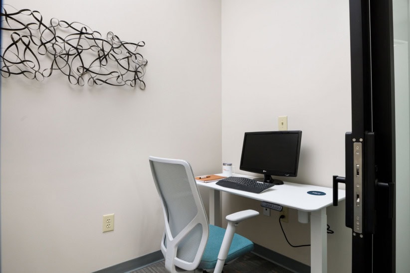 Modern office workspace with desk, computer, and ergonomic chair at Office Evolution.