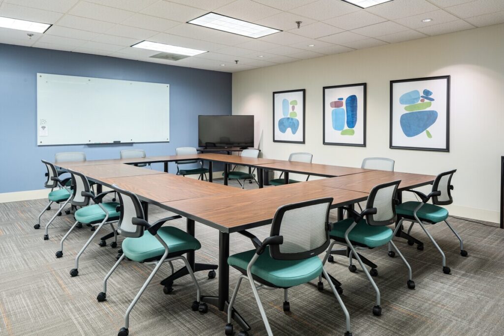 Meeting room with brown tables and blue chairs