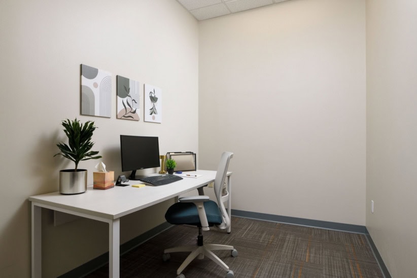 Modern office workspace with desk, computer, and decor in High Point.