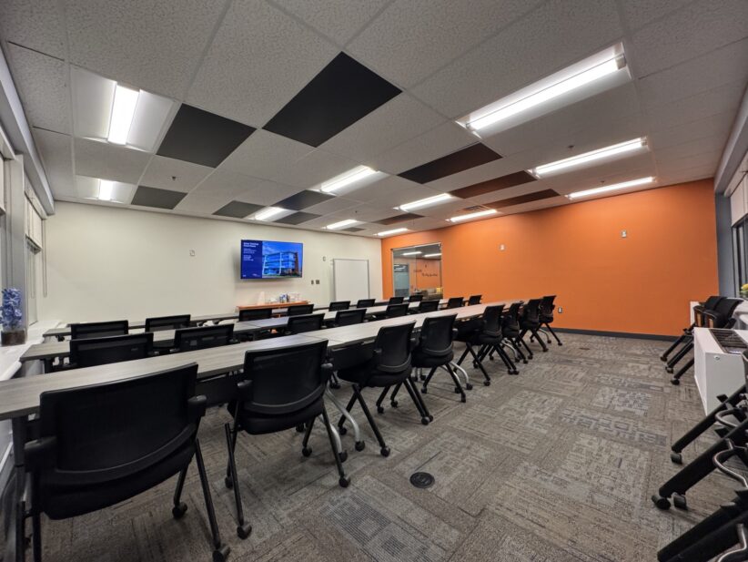 Modern conference room at Office Evolution coworking space with ergonomic chairs and presentation area.