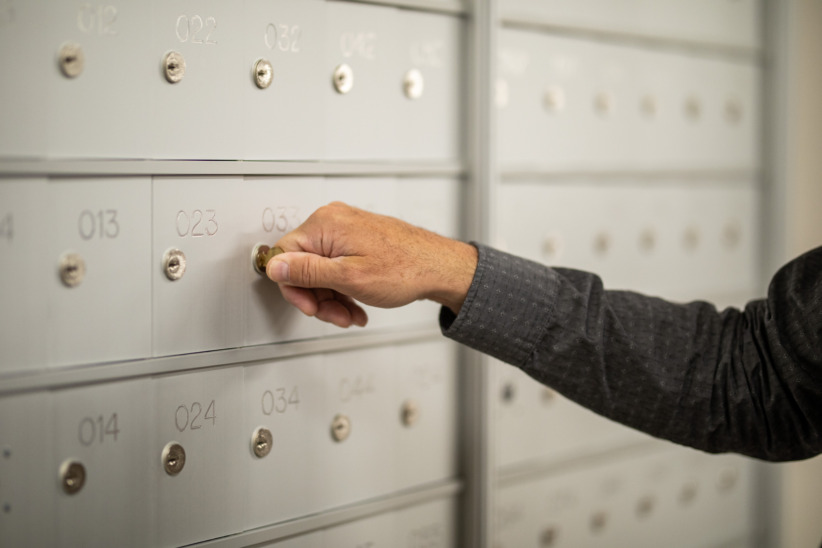 Secure mailbox with key at office setting for mail and package delivery.
