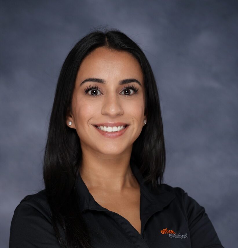Professional woman in Office Evolution Coral Springs uniform smiling confidently.