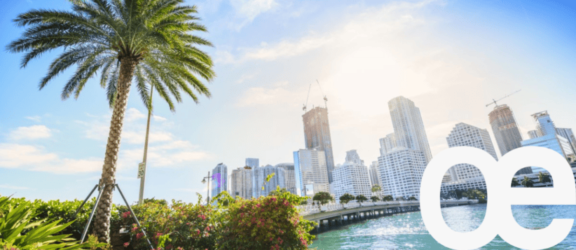 Modern city skyline with office buildings and waterfront, representing professional coworking spaces.