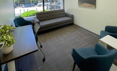 Contemporary office lounge with sofa and seating area at Office Evolution.