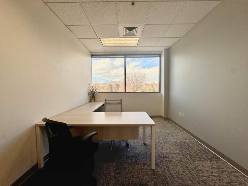 Private office with desk and chair at Office Evolution coworking space.