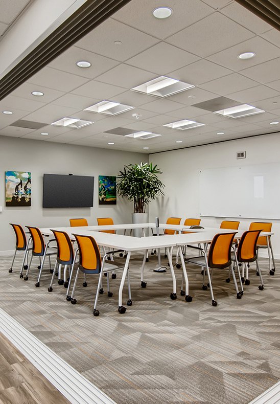 Conference Room with Orange chairs on a 20 person table