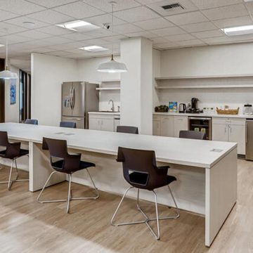 Coworking space inside Office Evolution with kitchen space.