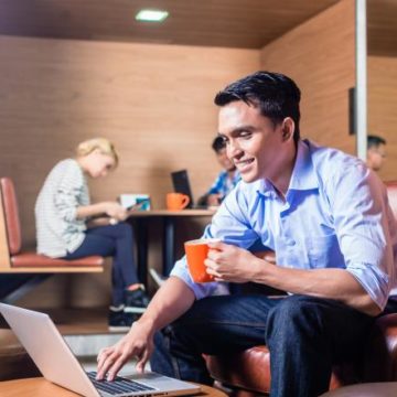 freelancer working on computer in coworking space