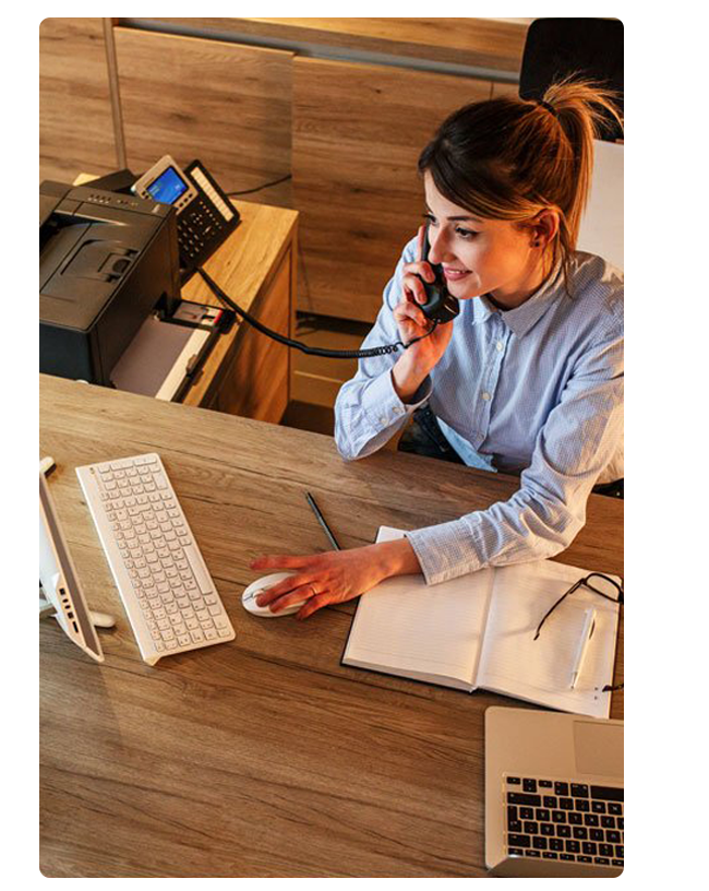 Women working at a desk answering a phone