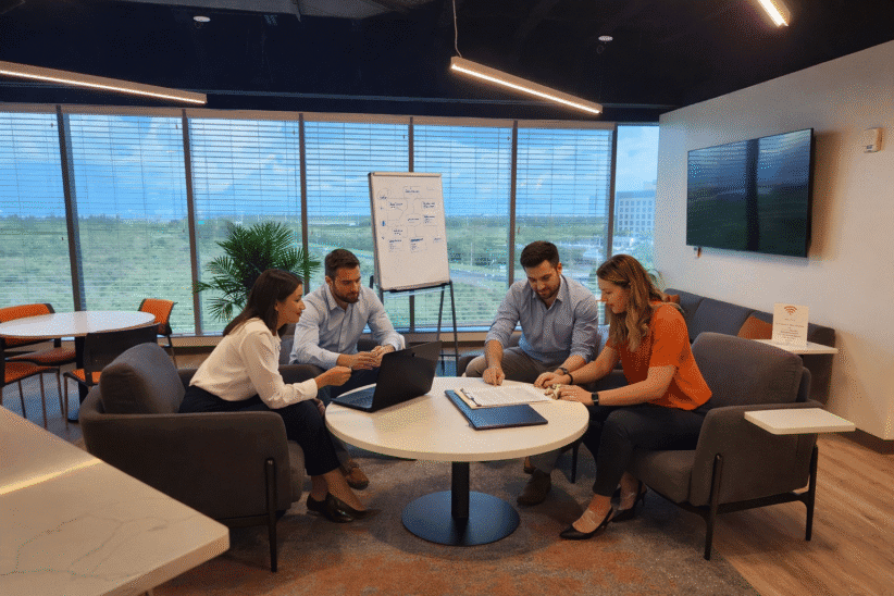 A team working together within the coworking lounge at Office Evolution Clearwater.