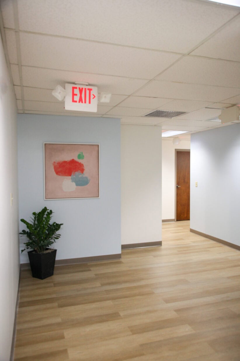 Office evolution coworking space interior with exit sign and decor.