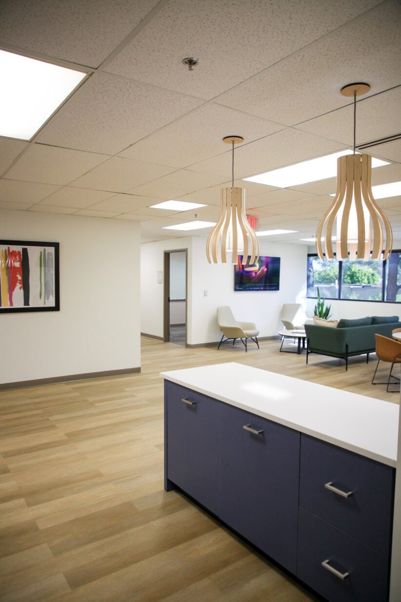 Modern office reception area with stylish lighting and comfortable seating at Office Evolution.