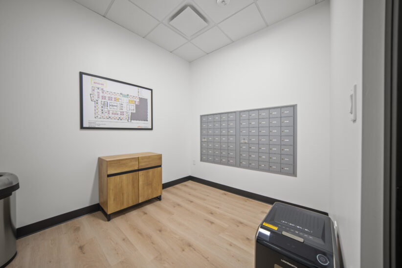 Mailbox area in modern office space, Office Evolution private work environment, coworking space mailing area, professional shared workspace mailboxes, relevant for small business offices.
