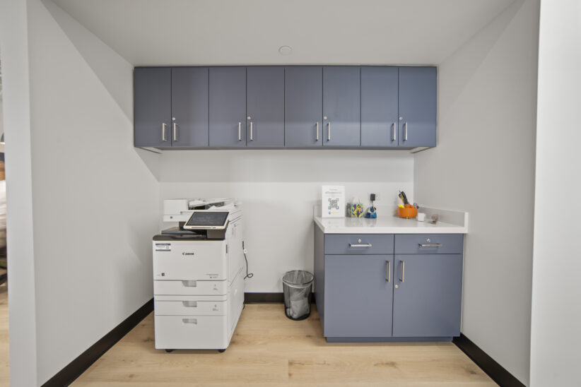 Office workspace with copier and storage cabinets at Office Evolution.