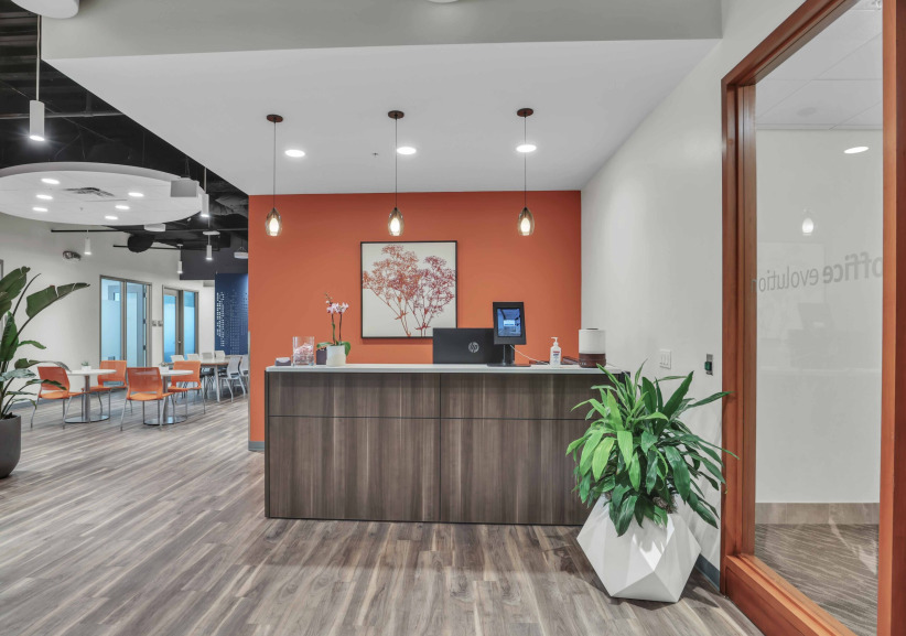 Modern office reception area with coworking space, featuring stylish decor and comfortable seating, ideal for entrepreneurs and remote workers.