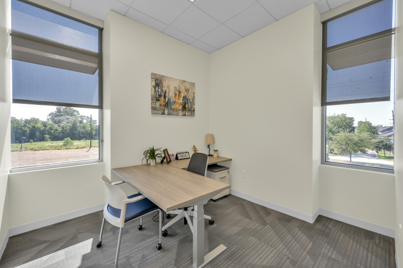 Modern office workspace with natural light and minimal decor at Office Evolution for flexible work solutions.