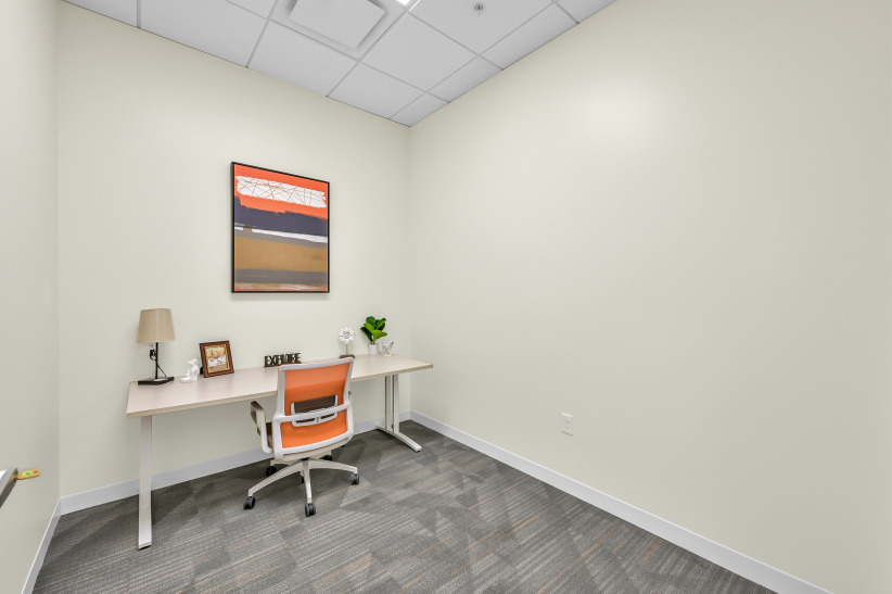 Quiet private office space with a desk, chair, and decorative accents for productive work environments.