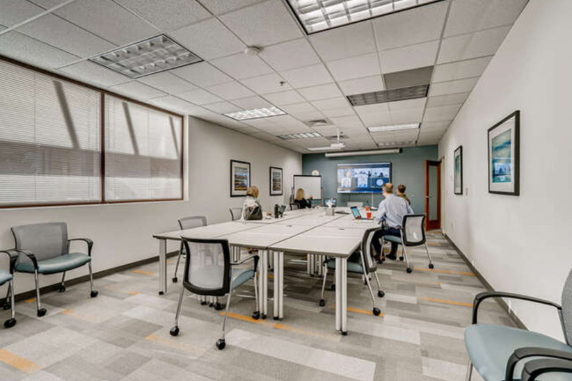 Modern shared office space with collaborative desks and meeting areas.