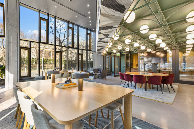 Modern office workspace with large windows and stylish meeting areas at Office Evolution.