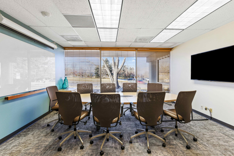 Modern professional office conference room with large windows and ergonomic chairs for meetings and collaboration.