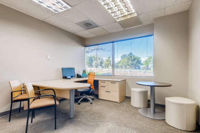 Office evolution business office interior with seating and desk setup.