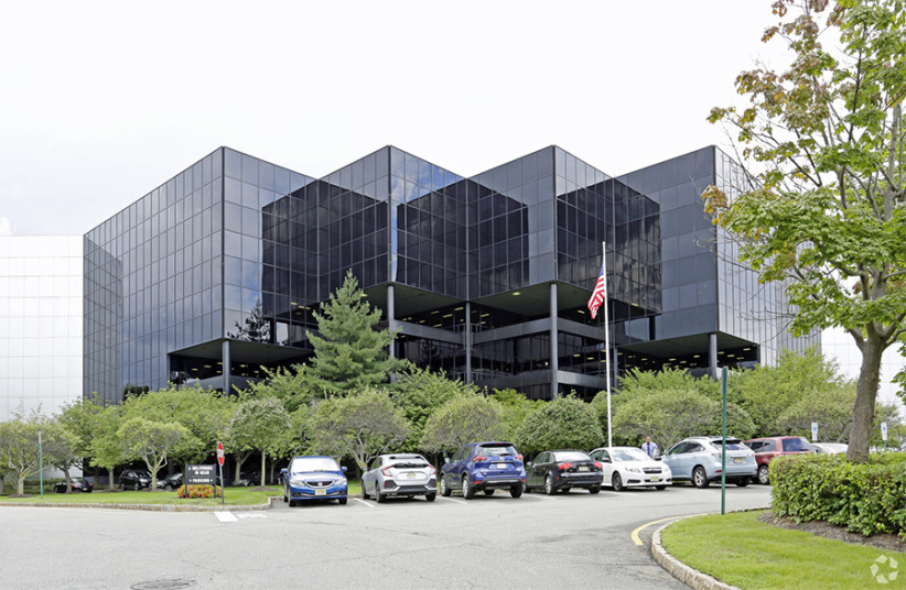 Modern office building with glass facade at Office Evolution campus in a business park setting.