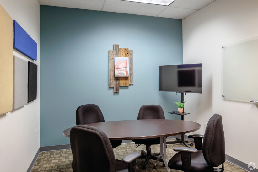 Modern office meeting room with conference table and chairs for coworking space.