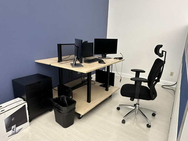 Office workspace with dual monitors and ergonomic chair for remote work and meetings, modern office setup.