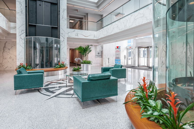 Office evolution apartment lobby modern corporate reception area with seating and greenery.