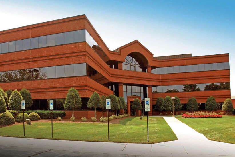 Flexible office workspace solutions at Office Evolution in a modern office building outdoor view.