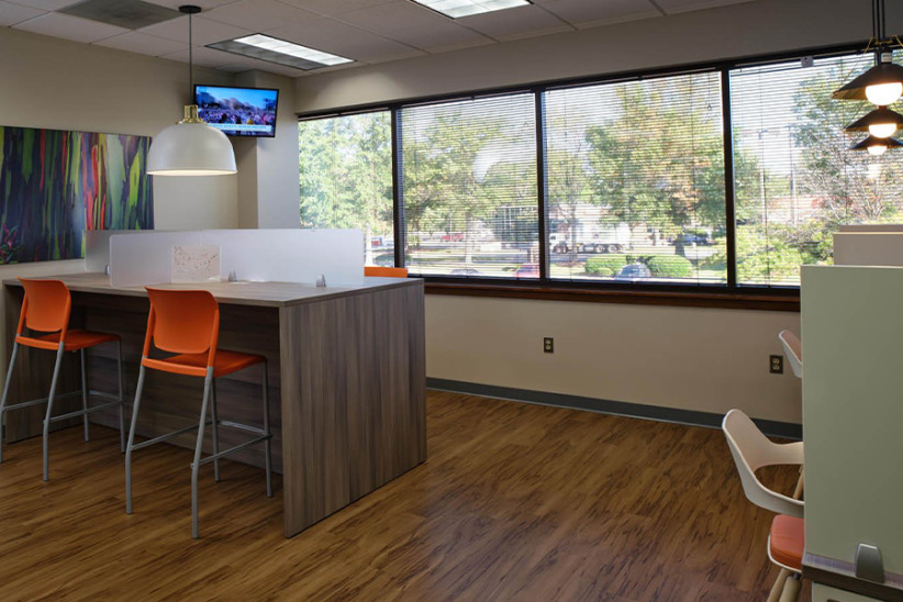 Modern coworking office space with bright lighting and large windows at Office Evolution.