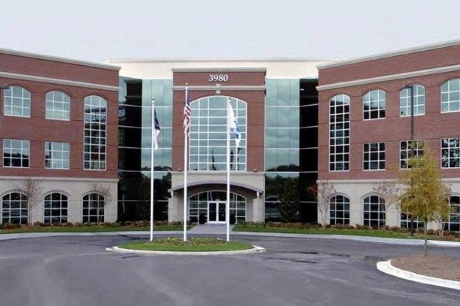 Office Evolution coworking space building with modern glass and brick facade.
