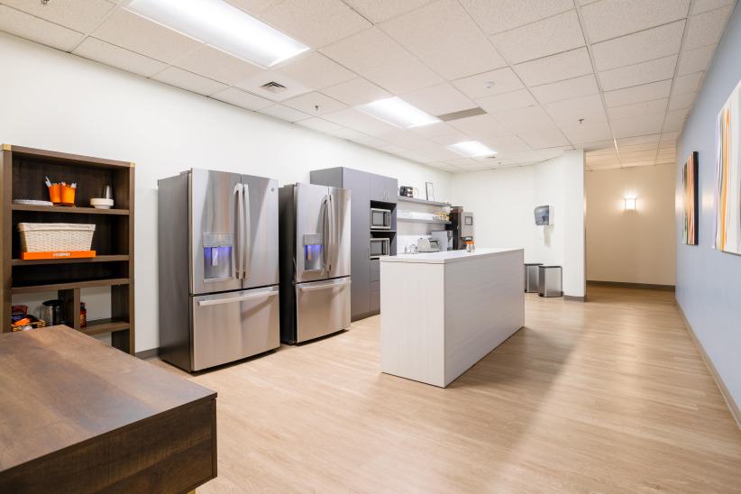 Refrigerators in a modern office break room, Kitchen appliances at Office Evolution for employee convenience.