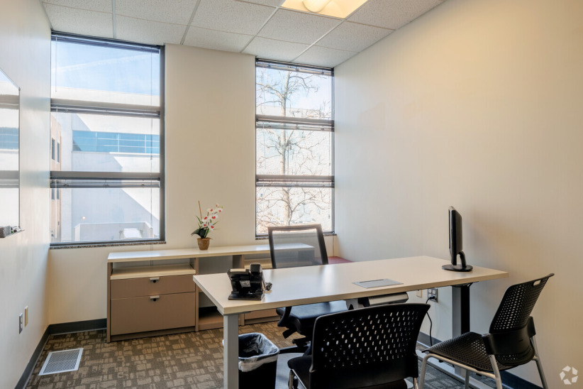 Modern office workspace with desk and computer for flexible business solutions.