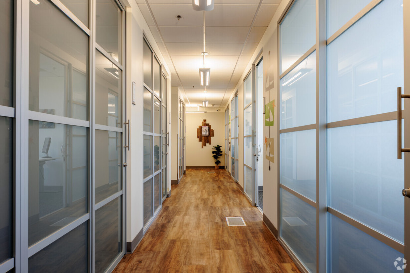 Office evolution private office suites with glass walls and modern decor.