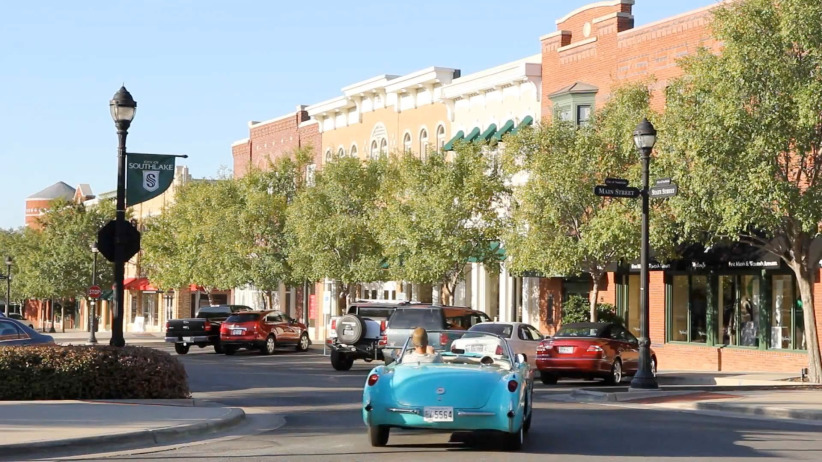 Office evolution coworking space in downtown Main Street storefronts and tree-lined sidewalks.