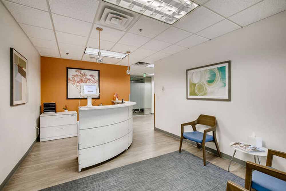 Modern office reception area with comfortable seating and contemporary decor.