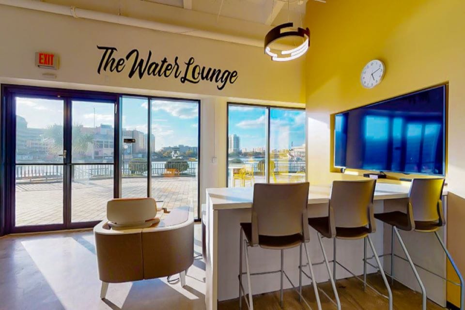 Modern coworking space with waterfront view and lounge area at Office Evolution.