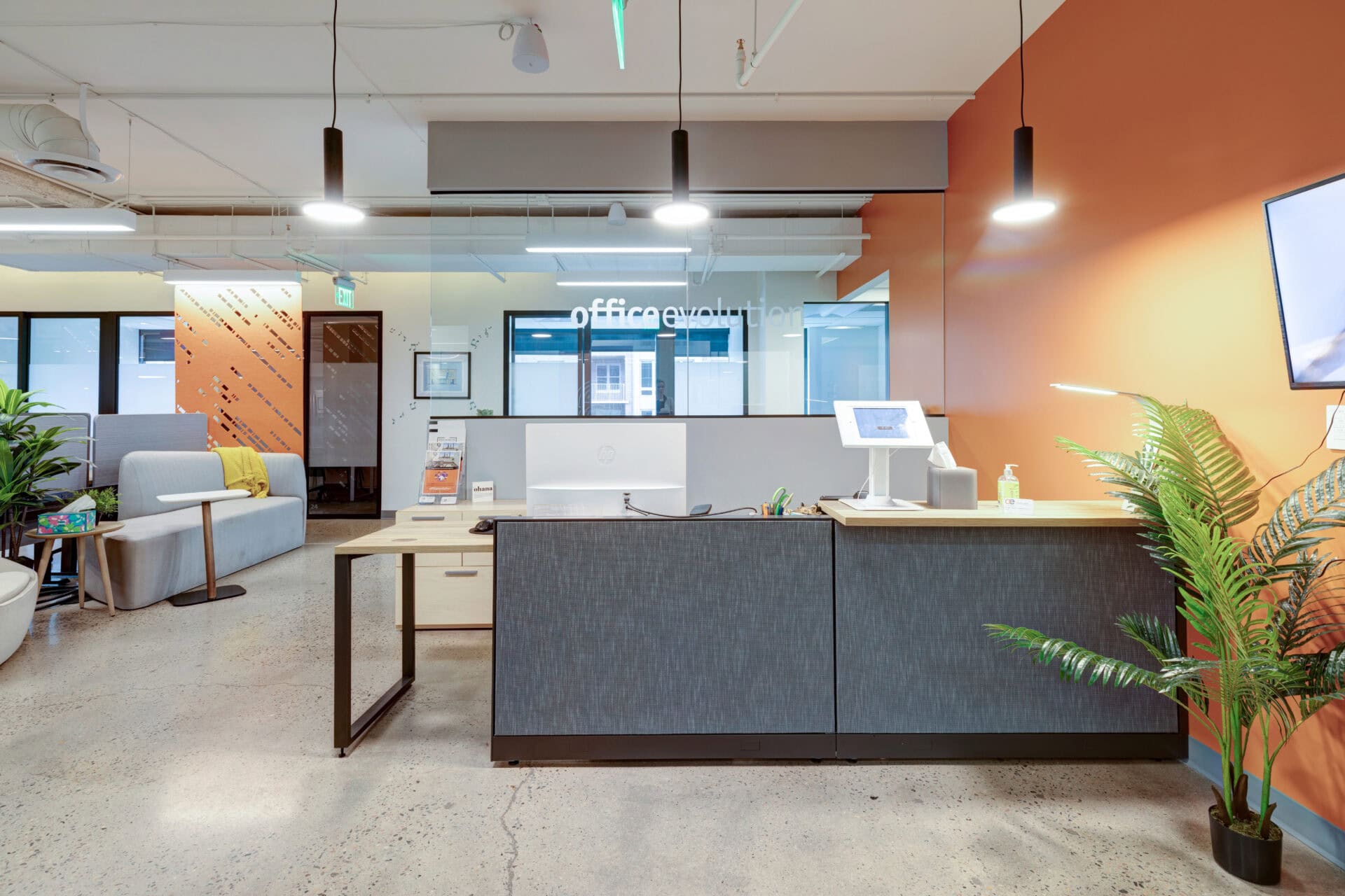 Bright modern office reception area with coworking spaces and stylish decor for flexible workspace solutions.