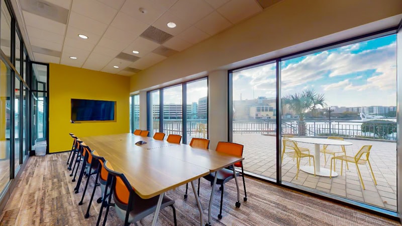 Bright modern conference room with large windows and outdoor patio at Office Evolution office space.