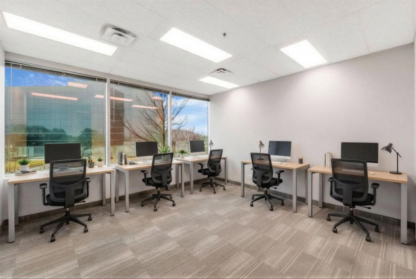 Office Evolution Oakville coworking workspace with desks and computers for professionals.