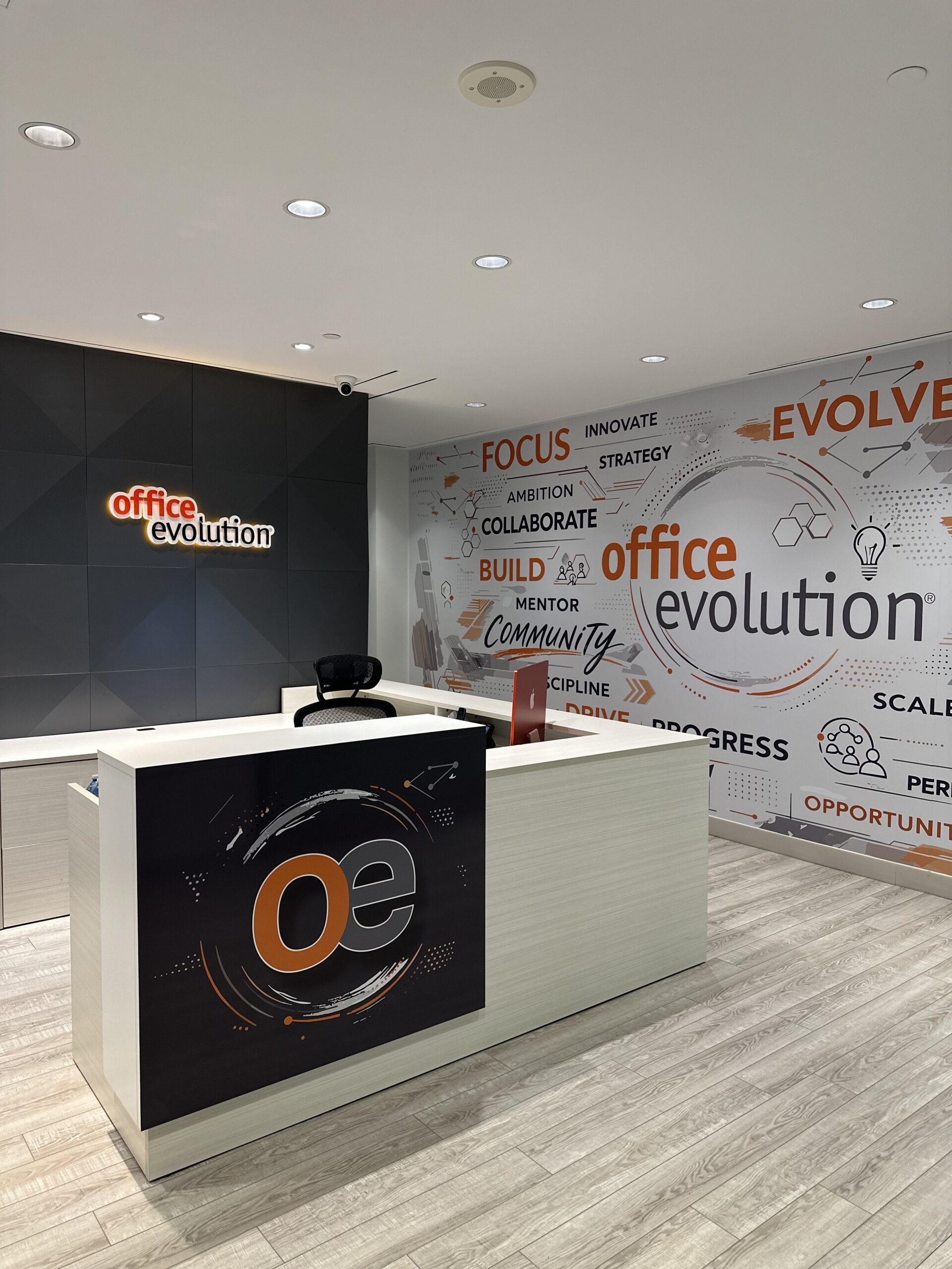 Modern Office Evolution reception desk in Oakville workspace.