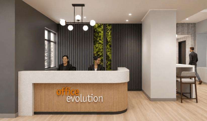 Flexible coworking space reception area at Office Evolution with modern decor and friendly staff.