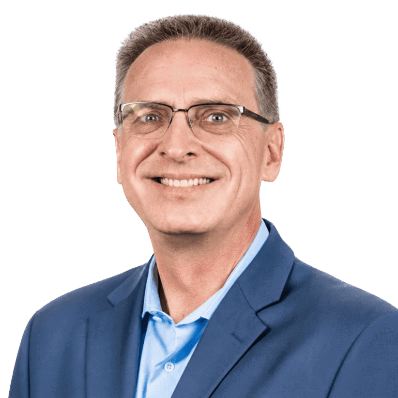 Professional man in blue suit smiling for corporate portrait.