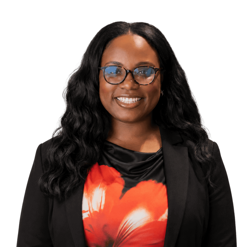 Professional woman with glasses smiling in office setting.