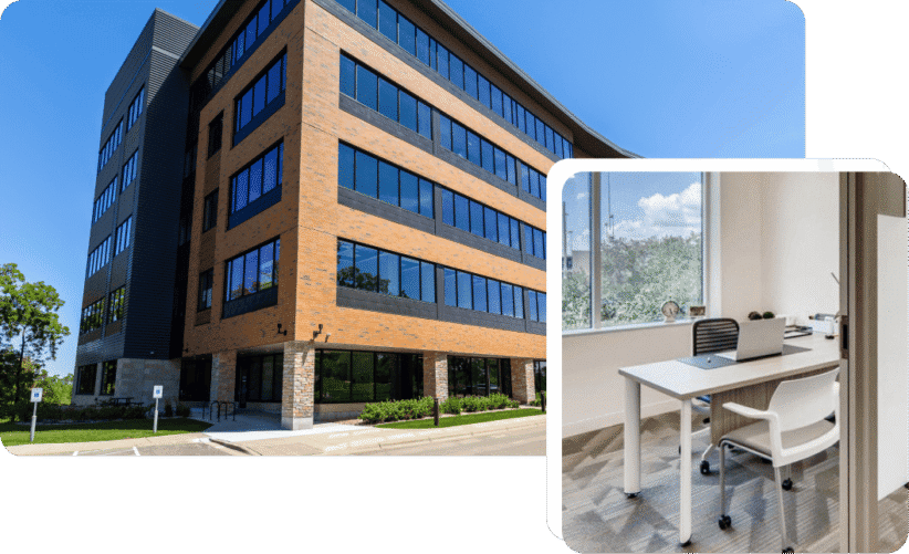 Modern office building with glass windows and brick facade in daylight.